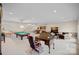 Open basement with pool table, wet bar, and comfortable seating area at 213 Patternote Rd, Mooresville, NC 28117