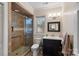 Bathroom with dark vanity and tile walk-in shower at 213 Patternote Rd, Mooresville, NC 28117