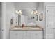 Elegant bathroom with double sinks, granite countertops, and bright lighting at 213 Patternote Rd, Mooresville, NC 28117