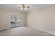 Bedroom with carpet floors and glass doors to the outside at 213 Patternote Rd, Mooresville, NC 28117