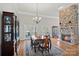 An elegant dining room with a stone fireplace and a formal dining table perfect for entertaining guests at 213 Patternote Rd, Mooresville, NC 28117
