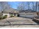 Charming home exterior featuring a well-manicured lawn, a spacious driveway, and a three-car garage at 213 Patternote Rd, Mooresville, NC 28117