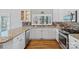 Bright kitchen featuring granite countertops, stainless steel appliances, a window over the sink, and hardwood floors at 213 Patternote Rd, Mooresville, NC 28117