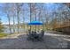 Lakeside patio with table and chairs, and an umbrella at 213 Patternote Rd, Mooresville, NC 28117