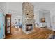 Bright living room featuring a stone fireplace, hardwood floors, and neutral décor for a cozy atmosphere at 213 Patternote Rd, Mooresville, NC 28117
