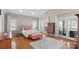 Bright main bedroom with hardwood floors, area rug, and doors to a balcony at 213 Patternote Rd, Mooresville, NC 28117