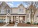 Charming brick and vinyl townhome featuring a covered porch, perfect for relaxing outdoors at 2511 Brackley Nw Pl # 1013, Concord, NC 28027