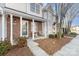 Inviting front porch of a townhome featuring brick accents and cozy seating area at 2511 Brackley Nw Pl # 1013, Concord, NC 28027