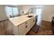 Bright kitchen with white cabinetry, stainless steel appliances, and an island overlooking the dining and living areas at 2847 Legacy Ridge Ln, Catawba, NC 28609