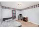 Cozy bedroom featuring light blue walls with diamond-patterned border, neutral carpet and natural light at 2888 Robinson Rd, Newton, NC 28658