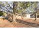 An angle view of a single-story brick home with front-facing garage on a tree-covered lot at 2888 Robinson Rd, Newton, NC 28658