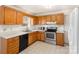 Well-lit kitchen featuring stainless steel appliances and plentiful wood cabinets at 2888 Robinson Rd, Newton, NC 28658