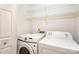 A bright laundry room with white appliances and storage shelves, providing a functional space at 2888 Robinson Rd, Newton, NC 28658