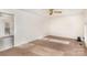 A spacious, light-filled living room with carpet flooring and a ceiling fan at 2888 Robinson Rd, Newton, NC 28658
