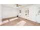 Bright living room features large windows, neutral carpet, and a classic ceiling fan at 2888 Robinson Rd, Newton, NC 28658