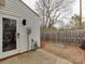 Backyard features a wooden fence, concrete patio and mulched planting bed at 307 French St, Charlotte, NC 28216