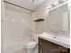 Bathroom featuring subway tile, wood shelf, modern vanity, toilet and tub at 307 French St, Charlotte, NC 28216