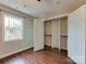 Bedroom featuring hardwood floors, natural light and open closet at 307 French St, Charlotte, NC 28216
