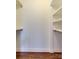 Walk-in closet with shelving and hardwood floors at 307 French St, Charlotte, NC 28216