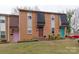A full exterior view of a brick townhome with colorful doors and well-maintained landscaping at 307 French St, Charlotte, NC 28216