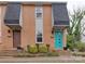 A close exterior view of a brick townhome with colorful doors and well-maintained landscaping at 307 French St, Charlotte, NC 28216