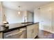 Updated kitchen with dark countertops, modern cabinets, and stainless steel appliances create a sleek and functional cooking space at 307 French St, Charlotte, NC 28216