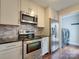Modern kitchen with stainless steel appliances, chic backsplash, and bright cabinets offers a stylish and functional cooking space at 307 French St, Charlotte, NC 28216