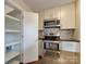 Well-organized kitchen features a pantry, stainless steel appliances, and a modern backsplash, combining convenience with style at 307 French St, Charlotte, NC 28216