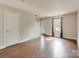Bright living room with wood floors, a large window, and neutral wall colors at 307 French St, Charlotte, NC 28216