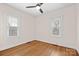 Bright bedroom with hardwood floors, two windows, and a ceiling fan at 333 7Th Nw St, Hickory, NC 28601