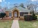 Charming brick home featuring a manicured lawn, covered entryway, and attractive landscaping at 333 7Th Nw St, Hickory, NC 28601