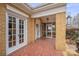 Inviting front porch featuring brick flooring, brick pillars, and a screened-in area at 333 7Th Nw St, Hickory, NC 28601