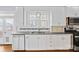 Bright kitchen features white cabinetry, stainless steel appliances, and hardwood flooring at 333 7Th Nw St, Hickory, NC 28601