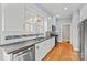 Updated kitchen featuring stainless steel appliances, white cabinets, and beautiful hardwood floors at 333 7Th Nw St, Hickory, NC 28601