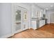 Open kitchen area with white cabinets and stainless steel appliances, french doors to deck at 333 7Th Nw St, Hickory, NC 28601