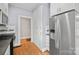 This kitchen features stainless steel refrigerator, white cabinetry and hardwood flooring at 333 7Th Nw St, Hickory, NC 28601