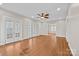 Expansive living room showcasing hardwood floors, a ceiling fan, and access to multiple rooms at 333 7Th Nw St, Hickory, NC 28601
