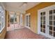Charming screened-in porch boasting a brick floor, ceiling fan, and access to the home's interior at 333 7Th Nw St, Hickory, NC 28601