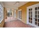 Spacious screened-in porch with brick flooring, ceiling fan, and access to the home's interior at 333 7Th Nw St, Hickory, NC 28601