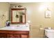 Bathroom with wooden vanity, framed mirror, modern fixtures, and decorative accents for a warm feel at 4238 Johnson Bridge Rd, Hickory, NC 28602