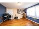 This spacious bedroom features hardwood floors, blue accent walls, and ample natural light from the large window at 4238 Johnson Bridge Rd, Hickory, NC 28602