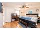Bedroom with ceiling fan, wooden desk, bed with blue accents and a window offering ample natural light at 4238 Johnson Bridge Rd, Hickory, NC 28602