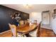 Dining room with decorative black wall, hardwood floors, and large wooden table at 4238 Johnson Bridge Rd, Hickory, NC 28602