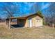 Exterior view of the detached garage with a carport and roll-up door at 4238 Johnson Bridge Rd, Hickory, NC 28602