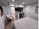 Comfortable bedroom with a breakfast bar, modern decor, and open bathroom view at 4317 Ruskin Dr, Charlotte, NC 28209