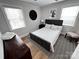 Bedroom featuring large windows, carpet, and dark wood furniture at 4317 Ruskin Dr, Charlotte, NC 28209