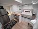 Cozy bedroom featuring a kitchenette, queen bed, modern decor, and a bright atmosphere at 4317 Ruskin Dr, Charlotte, NC 28209