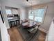 Cozy dining room featuring a wood table, modern chandelier, and adjacent kitchen area at 4317 Ruskin Dr, Charlotte, NC 28209