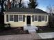 Charming home featuring yellow siding, black shutters and front door, and a lovely landscaped yard at 4317 Ruskin Dr, Charlotte, NC 28209