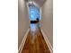 Clean hallway with hardwood floors leads to a bedroom with natural light at 4317 Ruskin Dr, Charlotte, NC 28209